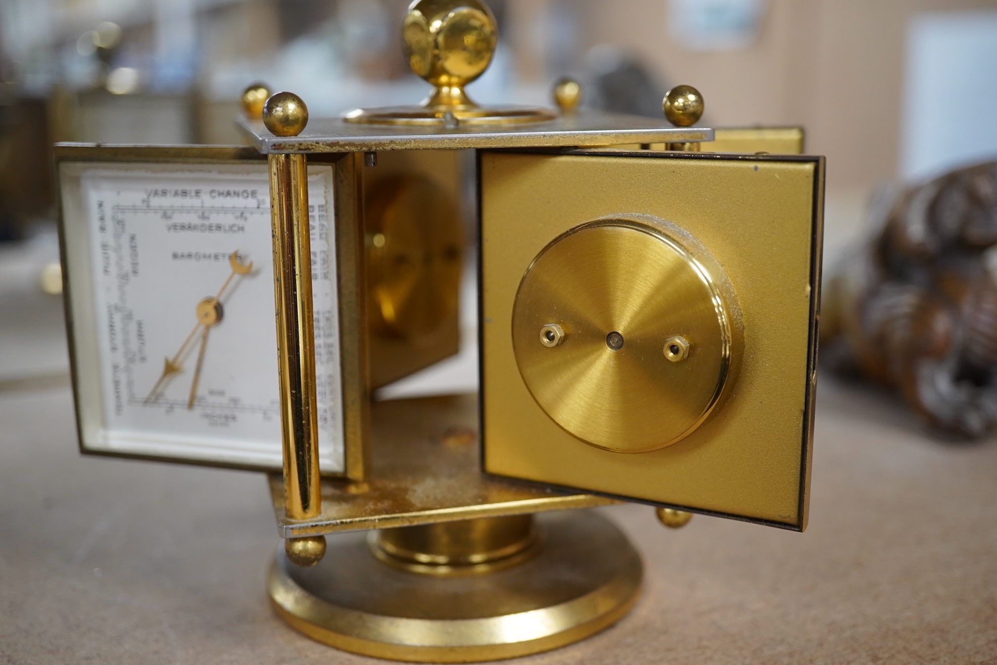 An Imhof brass combination clock, hydrometer, barometer and thermometer, 12cm high. Condition - fair